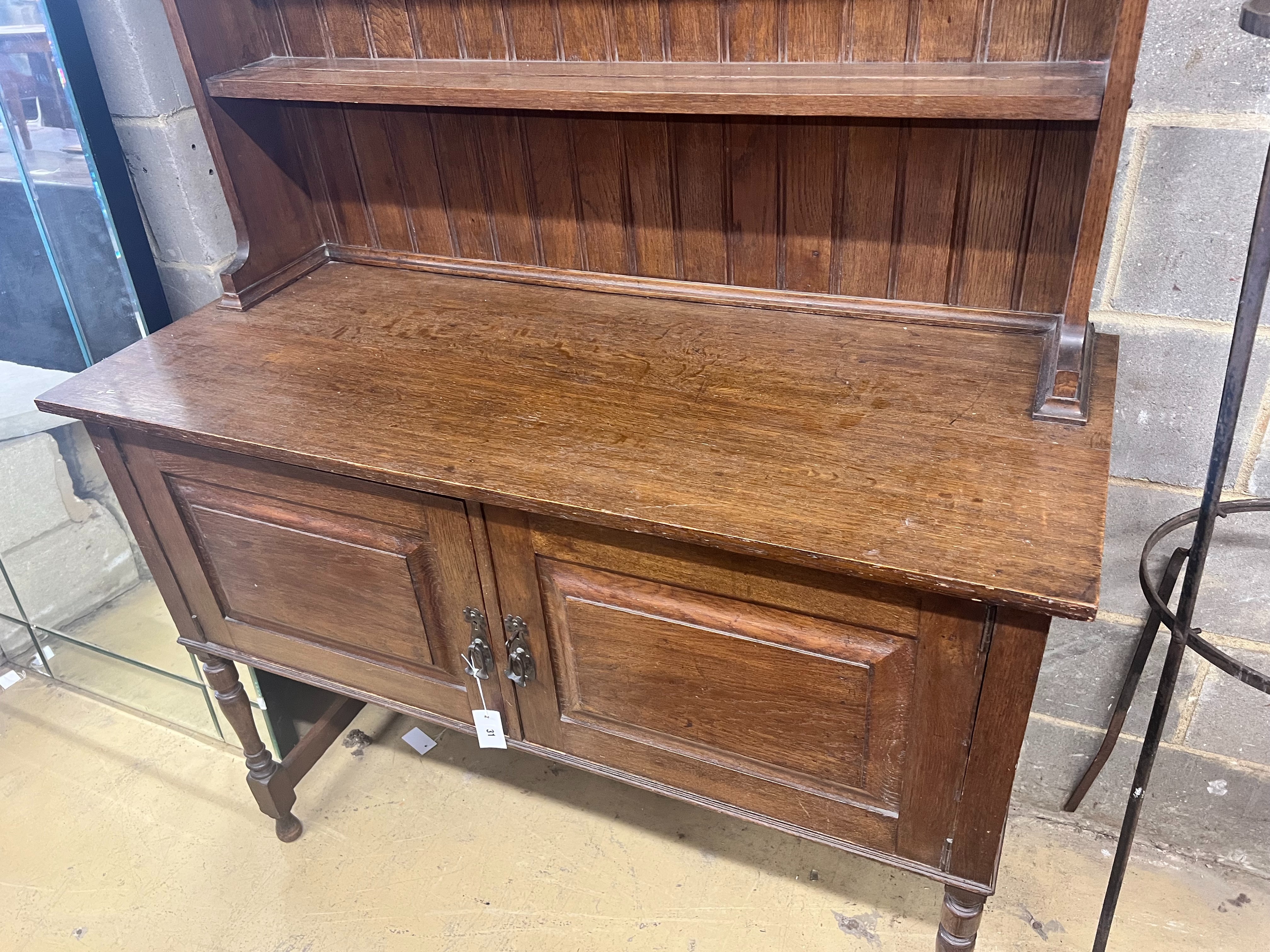 A 1920's oak dresser and plate rack, width 122cm, depth 51cm, height 211cm